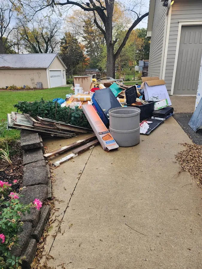 Dumpster being loaded with debris for Roofing Dumpster Rental in Glenolden